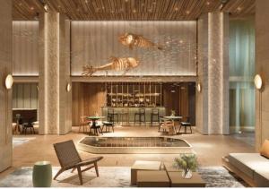 a lobby with a pool and tables and chairs at Beachfront Condotel - Free Pool Access - Apec Mandala Mui Ne in Ấp Thiẹn Ái