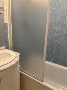 a bathroom with a shower and a sink at Résidence du Golf in Donville-les-Bains +10 photos