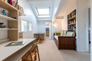 a home office with a skylight in the ceiling at Chambres d'hotes du Prieur in Léognan