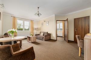 a living room with a couch and a table at Pałac nad Jeziorem in Chociwel +18 photos