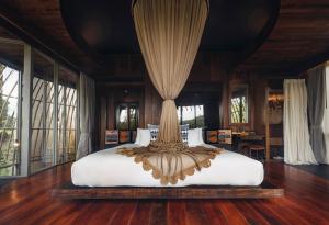 a large bed in a room with windows at Keemala in Kamala Beach +60 photos