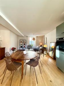 a kitchen and living room with a table and chairs at Savigny les Beaune city center in Savigny-lès-Beaune