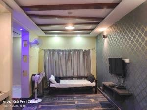 a room with a bed and a tv in it at bangalore residency in Srikalahasti