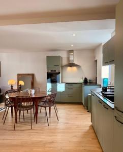 a kitchen and dining room with a table and chairs at Savigny les Beaune city center in Savigny-lès-Beaune