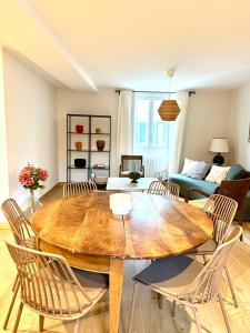 a living room with a wooden table and chairs at Casa Luna Burgundy in Savigny-lès-Beaune +2 photos