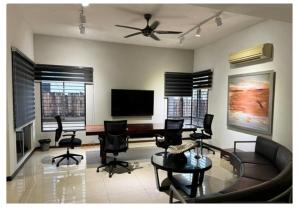 a living room with a couch and a table and chairs at JM House Kuala Lumpur in Puchong