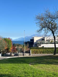 een park met een boom voor een gebouw bij Il Nido dei Cigni in Desenzano del Garda
