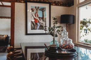 a table with a glass vase on top of it at Timata Ora - 7BR family home in prime location in New Plymouth