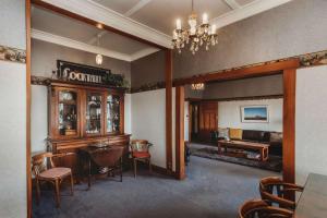 a living room with a table and chairs and a couch at Timata Ora - 7BR family home in prime location in New Plymouth