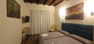 a bedroom with a bed with a blue head board at Hotel Rural Atalaya in Guadalupe +50 photos