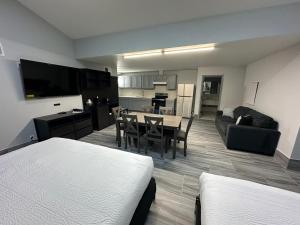 a living room with a dining table and a kitchen at Super 8 by Wyndham Texas City in Texas City