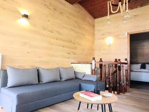 a living room with a blue couch and a table at G&J Traditional House in Elati