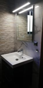 a bathroom with a sink and a mirror at G&J Traditional House in Elati Trikalon +22 photos