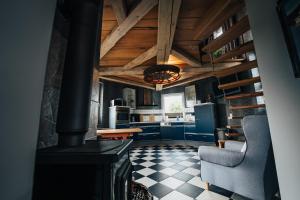 a kitchen with a stove and a chair in a room at Ferienhaus Getreidesilo in Schneverdingen