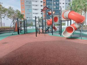 a playground with a slide in a park at D2303 Camellia Stay, Alanis Near KUL Airport in Sepang