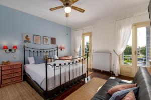 a bedroom with a bed and a couch at Villa Elmar in Aegina Town +66 photos