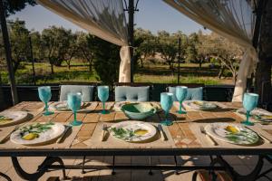 a table with plates of food and glasses on it at Villa Elmar in Aegina Town