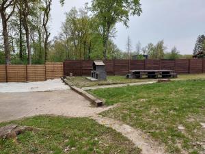 a park with a picnic table and a fence at Gîte du sanglier in Durbuy