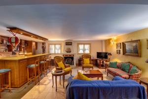 a living room filled with furniture and a bar at Villa Elmar in Aegina Town