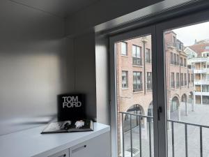 a room with a window with a view of a building at Modern Chromo Design Apartment Center Kortrijk in Kortrijk