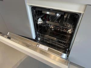 an oven with its door open in a kitchen at Modern Chromo Design Apartment Center Kortrijk in Kortrijk +19 photos