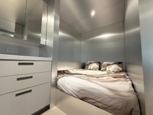 a small bedroom with a bed in the corner at Modern Chromo Design Apartment Center Kortrijk in Kortrijk