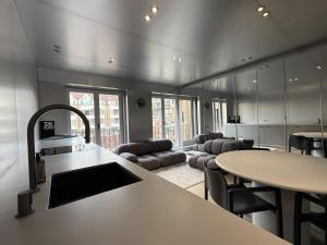 a kitchen and living room with a table and chairs at Modern Chromo Design Apartment Center Kortrijk in Kortrijk