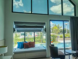 a room with a window with a bed and a pool at Gaia Luxury Pool Villa Khao Yai in Ban Bung Toei