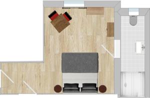 a floor plan of a room with a table and chairs at Gästehaus Jekle in Neuburg an der Kammel