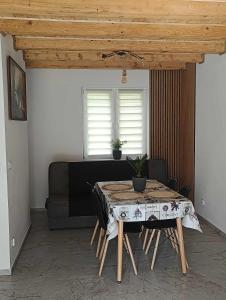 a table in a living room with a couch at Bieszczadzka Dolina u Magdy in Żołobek