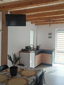a kitchen with a table and a counter top at Bieszczadzka Dolina u Magdy in Żołobek +22 photos