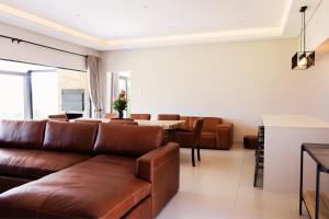 a living room with a couch and a table at 3BR Drakensberg Retreat, Mountain Views and Braai in Ardmore