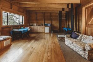 a living room with a couch and a table at The River Retreat - off the grid escape in Inglewood