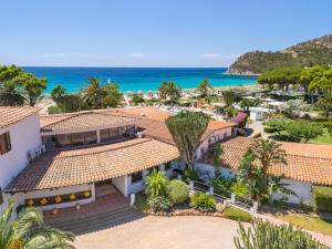 an aerial view of a resort with the ocean in the background at Cormoran Residence in Villasimius