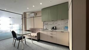 a kitchen with a table and a dining room at Set Sail Hotel in Uralsk