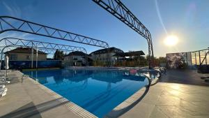 a large swimming pool with a crane in the background at Set Sail Hotel in Oral