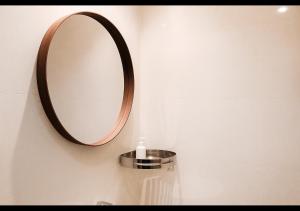 a bathroom with a mirror on the wall and a sink at Samara Stay by Sinergi in Kalibanteng-kidul