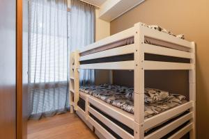 a white bunk bed in a room with a window at Utsun Gielas A5 Visit Levi in Levi