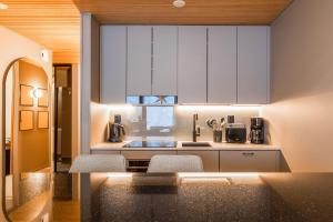 a kitchen with white cabinets and a counter top at Utsun Gielas A5 Visit Levi in Levi