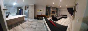 a living room with a couch and a kitchen at Bliss at Diaz in Mossel Bay