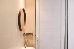 a bathroom with a sink and a mirror at Samara Stay by Sinergi in Kalibanteng-kidul
