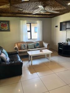 a living room with a couch and a coffee table at Ufudu Chalet in Mbazwana
