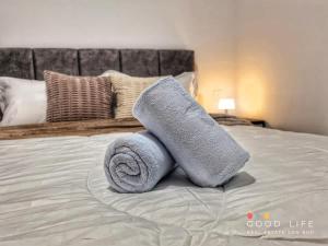 a pile of towels sitting on top of a bed at R&F Princess Cove Double Bed Room Shared Common Space in Johor Bahru