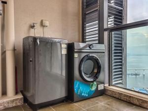 a washing machine sitting next to a window at R&F Princess Cove 2BR Sea View JB-SG Spacious in Johor Bahru