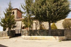 a building with two trees and a stone wall at El Solano-La Gallega in La Gallega +5 photos