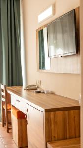 a kitchen counter with a sink and a mirror at Buyuk Berk Hotel in Ayvalık