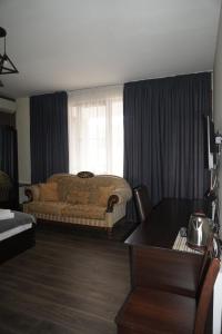 a bedroom with a bed and a table at Hotel New Terrace in Tbilisi City