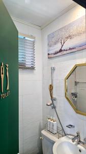 a bathroom with a sink and a toilet and a mirror at 와바다펜션 속초고성 독채펜션12인 삼포해수욕장1분 바베큐불멍 in Goseong