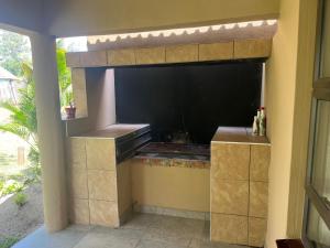 a kitchen in a house with a black wall at Ingwenya Chalet in Sodwana Bay