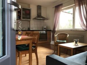 a kitchen and dining room with a table and chairs at Ferienhof Christmann in Mossautal